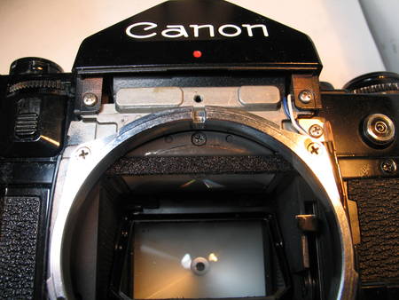 Canon A-1: macro of the focusing screen and the metal segment with the bumper foam.